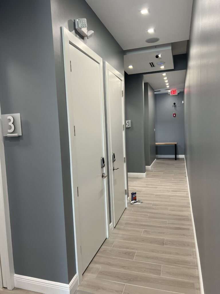 Modern office hallway with numbered doors.