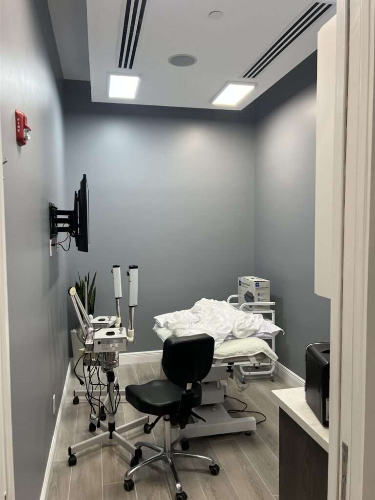 Modern medical examination room with equipment.